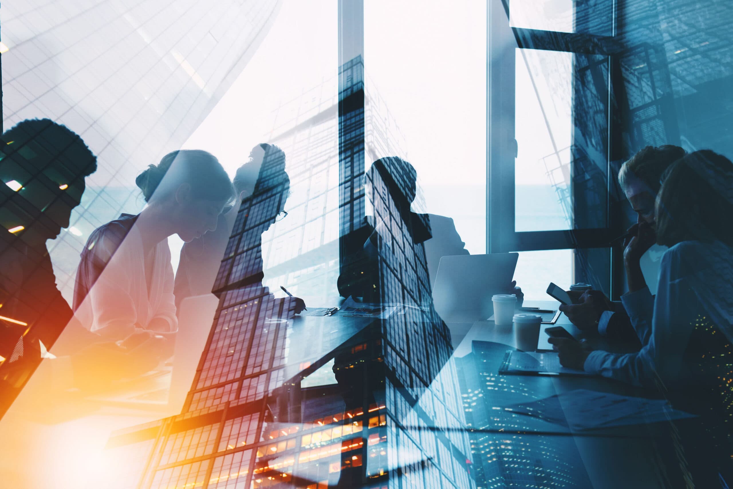 Double-exposure image of business professionals reviewing documents in a city office